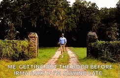 A Man Is Walking Down A Dirt Road In Front Of A Gate With A Quote From The Movie Forrest Gump . GIF