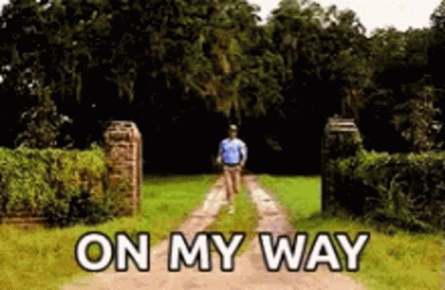 A Man Is Walking Down A Dirt Road With The Words On My Way Above Him GIF