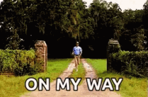 A Man Is Walking Down A Dirt Road With The Words On My Way Written On The Side . GIF