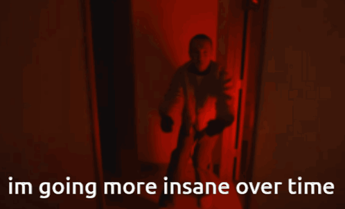 a man is walking down a hallway with the words im going more insane over time behind him