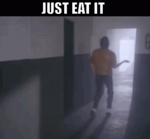 A Man Is Walking Down A Hallway With The Words Just Eat It On The Bottom GIF