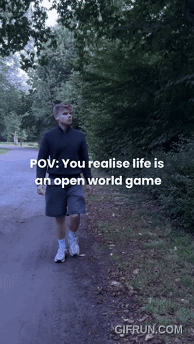 A Man Is Walking Down A Path With The Words " You Realise Life Is An Open World Game " GIF