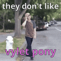 A Man Is Walking Down A Street Talking On A Cell Phone And They Don T Like Vylet Pony GIF
