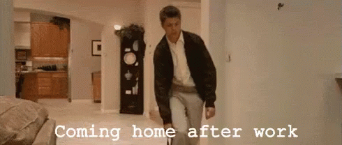 A Man Is Walking In A Hallway With The Words Coming Home After Work Written On The Wall Behind Him . GIF