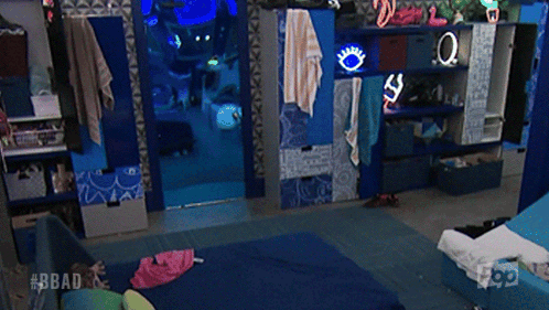 a man is walking in a room with the hashtag #bbad on the bottom