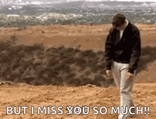 A Man Is Walking On A Beach With The Words `` But I Miss You So Much '' Written On The Bottom . GIF
