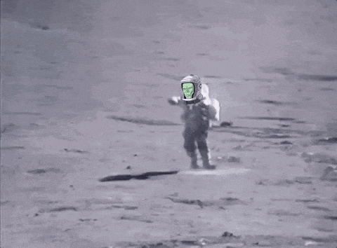 a man is walking on the moon with a green screen on his helmet .