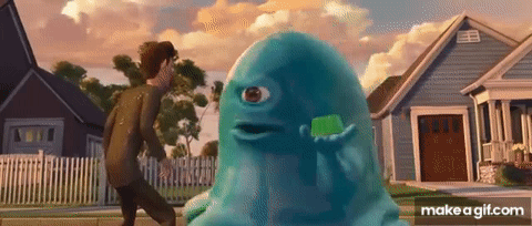 A Man Is Walking Past A Blue Monster With A Green Toothbrush . GIF