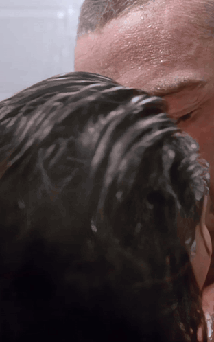 A Man Is Washing A Woman 'S Hair In The Shower GIF