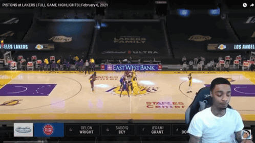 A Man Is Watching A Basketball Game Between The Pistons And Los Angeles Lakers GIF