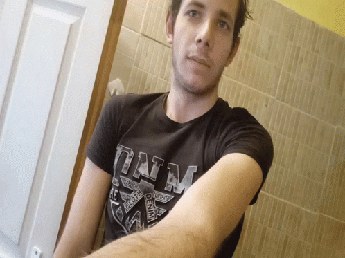 A Man Is Wearing A Black Shirt That Says Denim On It GIF