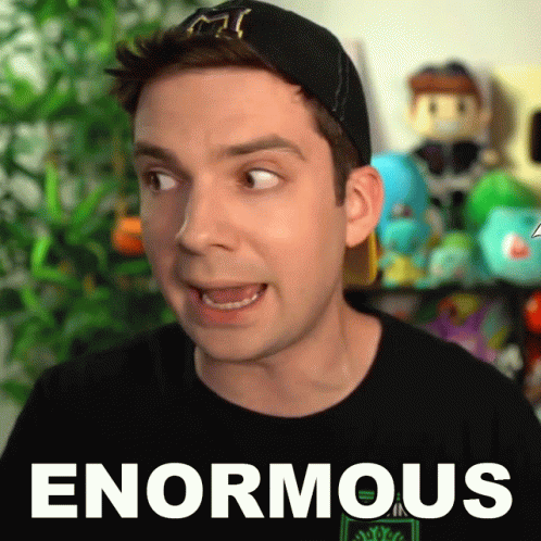 A Man Is Wearing A Black Shirt That Says Enormous On It GIF