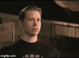 A Man Is Wearing A Black Shirt That Says G.r.k. On It GIF