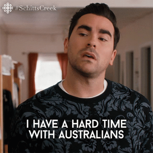 A Man Is Wearing A Black Shirt That Says I Have A Hard Time With Australians GIF