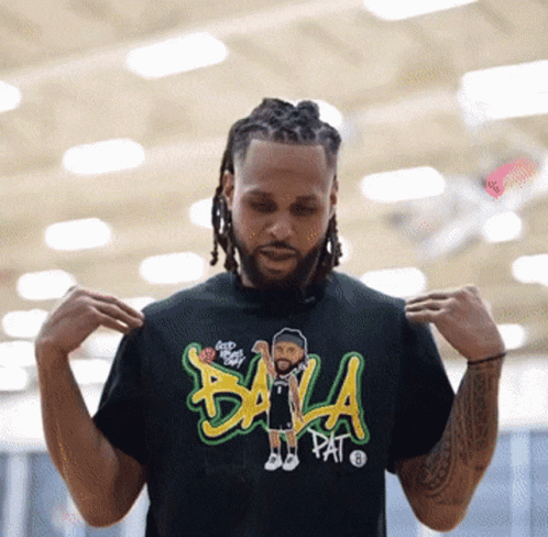 A Man Is Wearing A Black T-Shirt That Says Bala Pat On It GIF