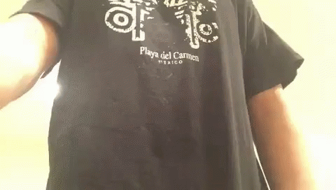 A Man Is Wearing A Black T-Shirt That Says Playa Del Carmen Mexico On It . GIF