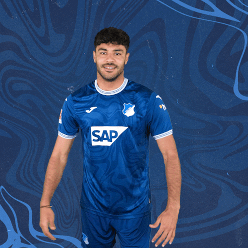 a man is wearing a blue shirt with the word sap on it