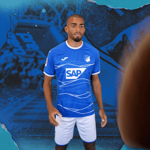 A Man Is Wearing A Blue Shirt With The Word Sap On It GIF