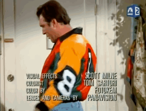 A Man Is Wearing A Colorful Jacket With The Number 8 On It GIF