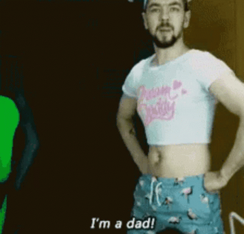 A Man Is Wearing A Crop Top And Shorts And Says I 'M A Dad . GIF