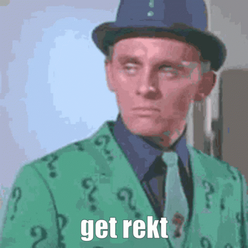 A Man Is Wearing A Green Suit With Question Marks On It GIF