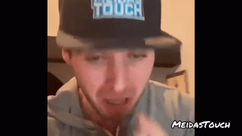 A Man Is Wearing A Hat That Says Touch On It GIF