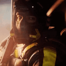A Man Is Wearing A Helmet And Headphones While Sitting In A Plane . GIF