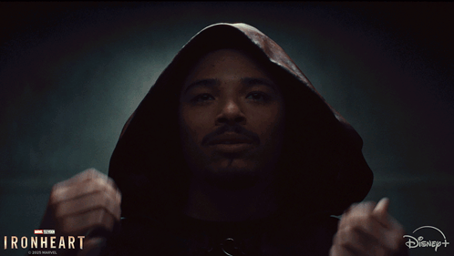 A Man Is Wearing A Hooded Jacket With The Words Ironheart On The Bottom GIF