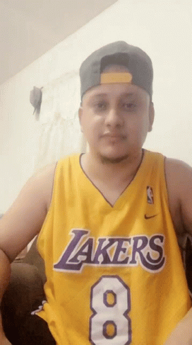 A Man Is Wearing A Lakers Jersey With The Number 8 On It GIF