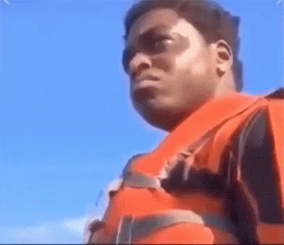 A Man Is Wearing A Life Jacket And Sunglasses . GIF