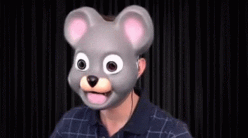 A Man Is Wearing A Mouse Mask With His Tongue Out . GIF