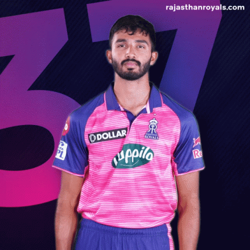 A Man Is Wearing A Pink And Blue Shirt With A Dollar Logo On It GIF