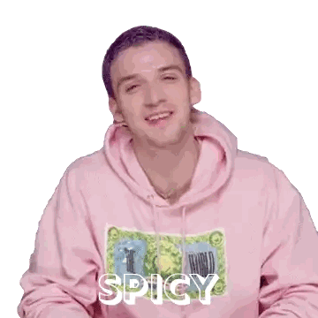 a man is wearing a pink hoodie that says spicy