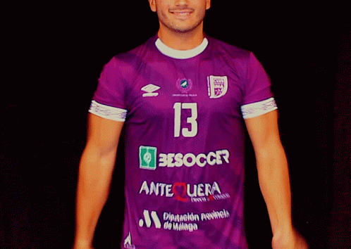 A Man Is Wearing A Purple Jersey With The Number 13 On It GIF