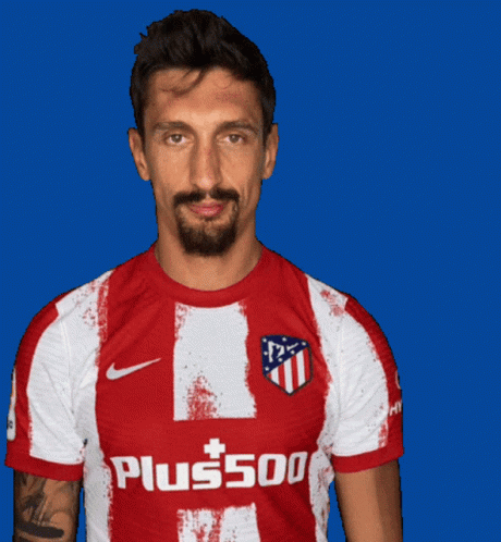 A Man Is Wearing A Red And White Shirt That Says Plus500 GIF