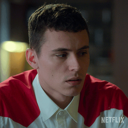 A Man Is Wearing A Red And White Shirt With Netflix Written On The Sleeve GIF