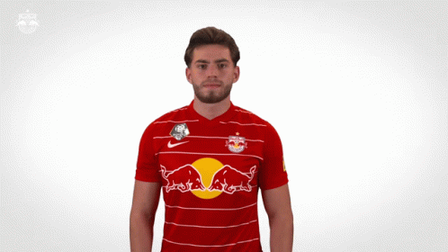 a man is wearing a red and white striped shirt with a red bull on it