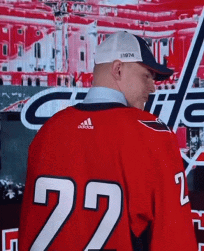 A Man Is Wearing A Red Jersey With The Number 22 On It GIF