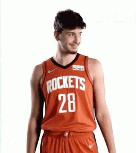 A Man Is Wearing A Red Rockets Jersey And Shorts . GIF