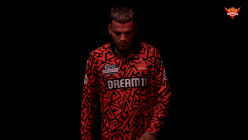 A Man Is Wearing A Red Shirt That Says Kent On It GIF