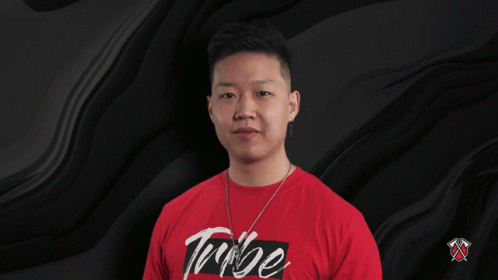 A Man Is Wearing A Red Shirt That Says Tribe On It GIF
