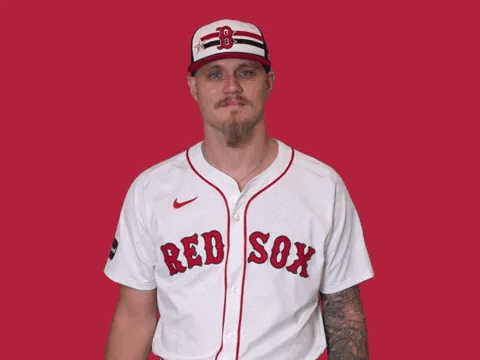 a man is wearing a red sox jersey and waving