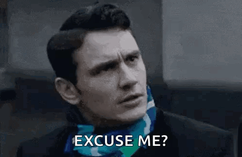 A Man Is Wearing A Scarf Around His Neck And Asking Someone To Excuse Him . GIF