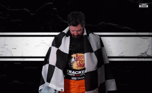 A Man Is Wearing A Shirt That Says Bass Pro Shop On It GIF