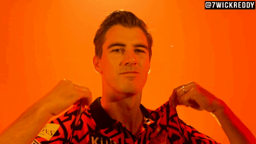 A Man Is Wearing A Shirt That Says ' Kuhl ' On It GIF