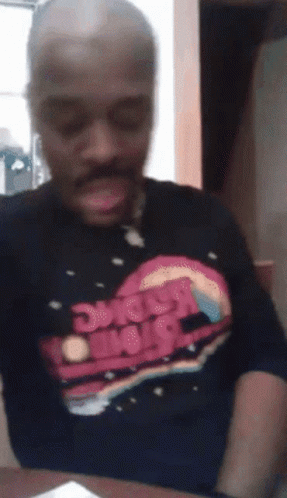 A Man Is Wearing A Shirt That Says Space Wars On It GIF