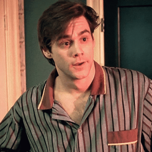 A Man Is Wearing A Striped Shirt And Looking At The Camera GIF
