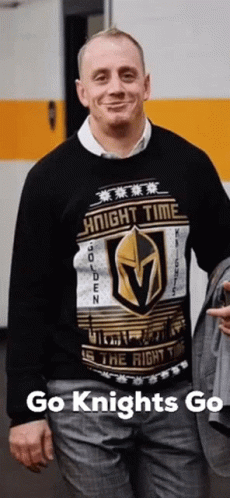 A Man Is Wearing A Sweater That Says Knight Time On It GIF