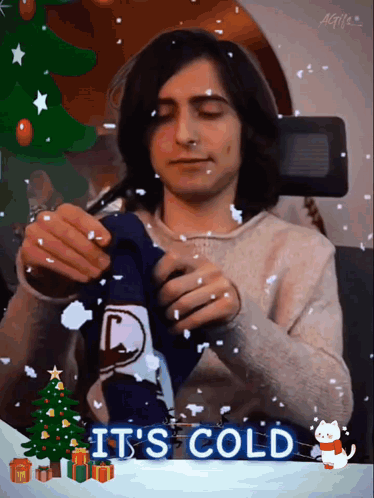 A Man Is Wearing A Sweater With The Words It 'S Cold Written On It GIF