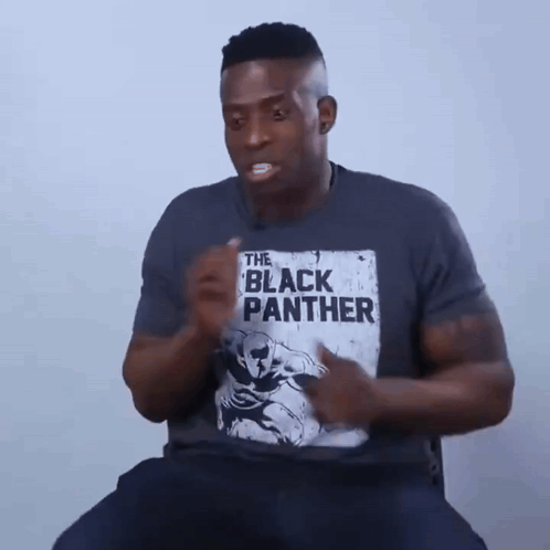 A Man Is Wearing A T-Shirt That Says The Black Panther On It GIF